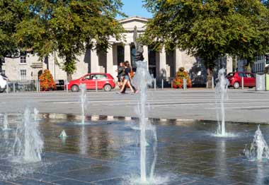 People walking by a water fountain, Dundalk